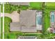 Overhead shot of a home with a brick driveway, a screened in pool, and manicured lawns at 13524 Glynshel Dr, Winter Garden, FL 34787