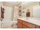 Bathroom featuring a vanity with sink, framed mirror, and a shower-tub combination at 13524 Glynshel Dr, Winter Garden, FL 34787