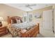 Cozy bedroom showcasing a wooden bed frame, plantation shutters, and neutral decor at 13524 Glynshel Dr, Winter Garden, FL 34787