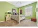 Green bedroom boasts a four-poster bed, plush carpet, and natural light from the shuttered window at 13524 Glynshel Dr, Winter Garden, FL 34787