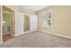 Spacious bedroom with neutral walls, carpet, large closets, and a window with plantation shutters at 13524 Glynshel Dr, Winter Garden, FL 34787