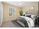 Cozy bedroom with a comfortable bed, soft carpet, and a shuttered window for natural lighting at 13524 Glynshel Dr, Winter Garden, FL 34787