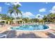 Community pool with lounge chairs and a poolside structure, creating a relaxing atmosphere at 13524 Glynshel Dr, Winter Garden, FL 34787