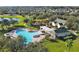 Community pool featuring ample seating, a playground, and a gazebo, nestled in a lush setting at 13524 Glynshel Dr, Winter Garden, FL 34787