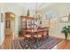 Formal dining room featuring a wood table, chandelier, and a large window for natural light at 13524 Glynshel Dr, Winter Garden, FL 34787