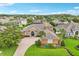 Well-maintained home with manicured lawn, mature landscaping, and brick driveway at 13524 Glynshel Dr, Winter Garden, FL 34787