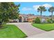 Stunning single-story home with lush landscaping and a winding brick driveway leading to a welcoming entrance at 13524 Glynshel Dr, Winter Garden, FL 34787