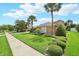 Charming single-story home featuring meticulously maintained landscaping with a green lawn, shrubbery, and mature palms at 13524 Glynshel Dr, Winter Garden, FL 34787