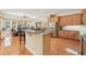 Modern kitchen featuring a breakfast bar, stainless steel appliances, and a view into the living room at 13524 Glynshel Dr, Winter Garden, FL 34787