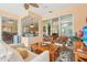 Enclosed lanai featuring comfortable seating, a ceiling fan, and views of the home's interior at 13524 Glynshel Dr, Winter Garden, FL 34787