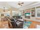 Inviting living room featuring a built-in bookcase, comfortable leather furniture, and natural light at 13524 Glynshel Dr, Winter Garden, FL 34787
