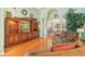 Bright living room featuring hardwood floors, a built-in entertainment center, and access to the lanai at 13524 Glynshel Dr, Winter Garden, FL 34787