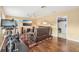 Inviting living room featuring hardwood floors, large TV, comfortable seating and adjacent storage at 13524 Glynshel Dr, Winter Garden, FL 34787