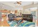 Open-concept living area with hardwood floors, and a view into the kitchen and dining areas at 13524 Glynshel Dr, Winter Garden, FL 34787