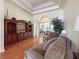 Cozy living room featuring hardwood floors, columns, and sliding glass doors to enclosed porch at 13524 Glynshel Dr, Winter Garden, FL 34787