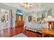 Bright main bedroom featuring a door to the lanai, wood floors, and a view into the bathroom at 13524 Glynshel Dr, Winter Garden, FL 34787