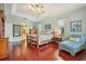 Elegant main bedroom with tray ceilings, a wooden bed frame and a chair with striped fabric at 13524 Glynshel Dr, Winter Garden, FL 34787
