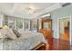 Sun-filled main bedroom boasting a pool view, a large wooden dresser and elegant tray ceilings at 13524 Glynshel Dr, Winter Garden, FL 34787