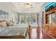 Bright main bedroom with built-in shelving, tray ceilings, and a view to the pool at 13524 Glynshel Dr, Winter Garden, FL 34787