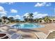 Enjoy the community pool, perfect for relaxation and recreation, surrounded by lounge chairs and lush landscaping at 13524 Glynshel Dr, Winter Garden, FL 34787