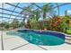 Screened pool with lush landscaping and water feature, offering a private tropical oasis at 13524 Glynshel Dr, Winter Garden, FL 34787