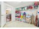 View of well-organized storage room with shelving and boxes, adjacent to the living room at 13524 Glynshel Dr, Winter Garden, FL 34787