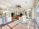 Bright sunroom featuring tile flooring, ceiling fan, comfortable seating, and access to multiple rooms at 13524 Glynshel Dr, Winter Garden, FL 34787