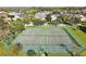 Aerial view of tennis courts ready for a match, showcasing the meticulously maintained green surfaces at 13524 Glynshel Dr, Winter Garden, FL 34787