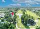 Aerial view of property near a golf course with lush greenery and a pond in a serene setting at 1387 Sawgrass Court, Winter Park, FL 32792