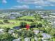 An aerial view of a lovely home near a golf course with lush greenery and a pond in a serene setting at 1387 Sawgrass Court, Winter Park, FL 32792
