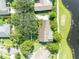Overhead view of the property's rooftop and greenery, with a golf course and pond nearby at 1387 Sawgrass Court, Winter Park, FL 32792