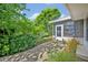 Well-maintained backyard features a mix of lush plants and bushes, as well as a sunny patio at 1387 Sawgrass Court, Winter Park, FL 32792