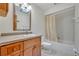 This bright bathroom includes a vanity with storage, a tub with shower, and a skylight at 1387 Sawgrass Court, Winter Park, FL 32792