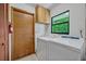 Convenient laundry room features a full-size washer and dryer, storage cabinets, and natural light at 1387 Sawgrass Court, Winter Park, FL 32792