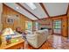 Living room with wood-paneled walls, brick fireplace, terracotta floors, and access to outdoor views at 1387 Sawgrass Court, Winter Park, FL 32792