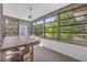 Enclosed sunroom featuring multiple large windows offering backyard views and natural light at 1387 Sawgrass Court, Winter Park, FL 32792