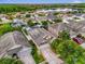 Aerial view of a residential neighborhood, showcasing manicured lawns and a serene lake in the background at 14617 Keelford Way, Orlando, FL 32824