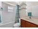Bright bathroom with a bathtub and shower combination with an undermount sink at 14617 Keelford Way, Orlando, FL 32824