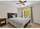 Comfortable bedroom featuring a ceiling fan, wood floors, and a window with natural light at 14617 Keelford Way, Orlando, FL 32824