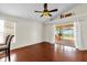 Bright bedroom with wood floors, a ceiling fan, and sliding glass doors to a screened-in patio at 14617 Keelford Way, Orlando, FL 32824