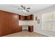 Bedroom with a built-in desk and shelving with a large closet and wood flooring at 14617 Keelford Way, Orlando, FL 32824
