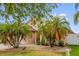 Well maintained, single Gathering home with mature palm trees and decorative rock in the front yard at 14617 Keelford Way, Orlando, FL 32824