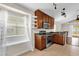 Modern kitchen with stainless steel appliances, granite countertops, and a window above a window seat at 14617 Keelford Way, Orlando, FL 32824