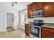 Well-equipped kitchen with stainless steel appliances, adjacent to a laundry room for added convenience at 14617 Keelford Way, Orlando, FL 32824