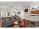 Spacious living area with wood floors, comfortable sofa, and views of the breakfast bar and dining space at 14617 Keelford Way, Orlando, FL 32824