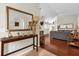 Open concept living room with wood floors, beige walls, and decorative console table by the entrance at 14617 Keelford Way, Orlando, FL 32824