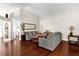Bright living room with wood flooring, vaulted ceilings, and neutral-colored sofas and decor at 14617 Keelford Way, Orlando, FL 32824