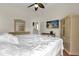 Spacious main bedroom with hardwood floors, ceiling fan, walk-in closet, and neutral decor at 14617 Keelford Way, Orlando, FL 32824