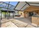 A screened patio featuring a gazebo, outdoor grill, and hot tub at 14617 Keelford Way, Orlando, FL 32824