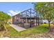 Exterior view of a screened patio featuring a gazebo, outdoor grill, and hot tub at 14617 Keelford Way, Orlando, FL 32824